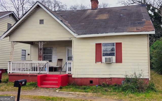 view of front of home featuring cooling unit and a porch