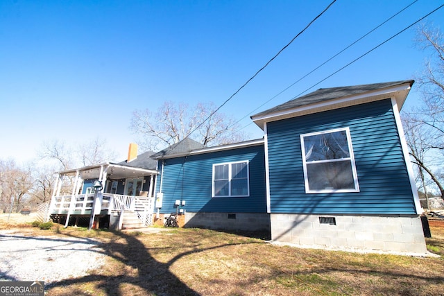 rear view of house with a porch and a yard