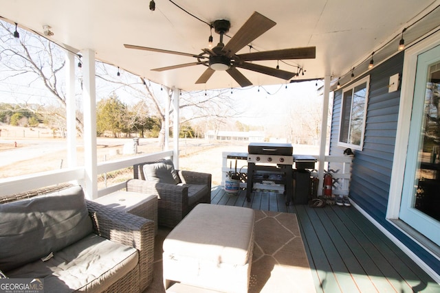 wooden terrace with outdoor lounge area, a grill, and ceiling fan