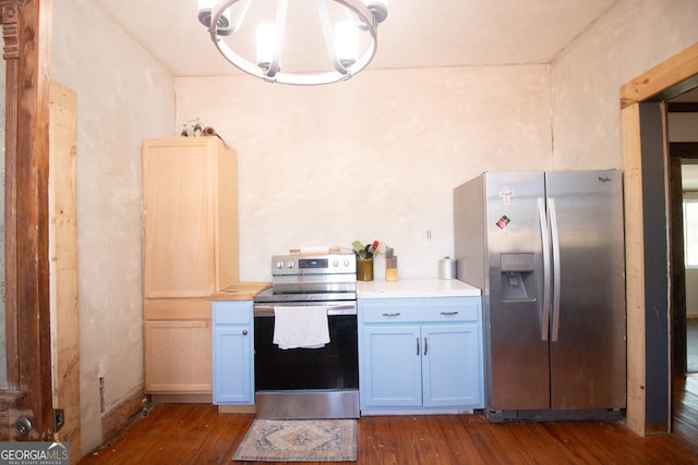 kitchen with pendant lighting, white cabinetry, dark wood-type flooring, and appliances with stainless steel finishes