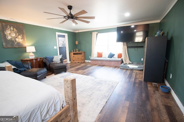 bedroom featuring wood-type flooring, ceiling fan, and crown molding