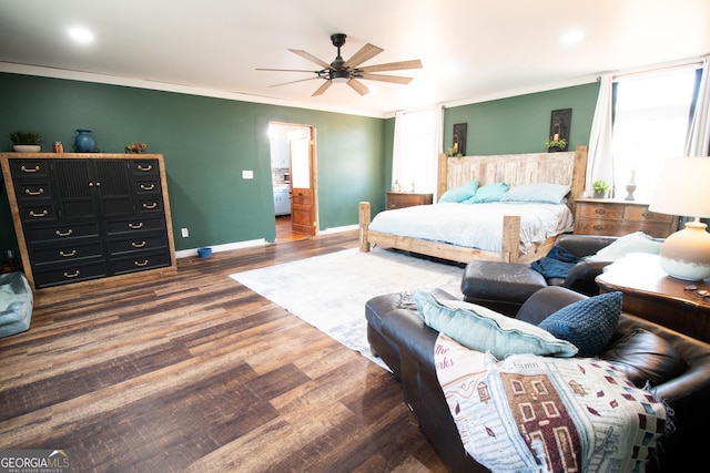 bedroom featuring crown molding, ceiling fan, and dark hardwood / wood-style flooring