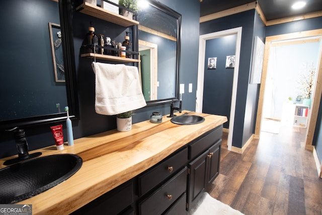 bathroom with vanity and wood-type flooring