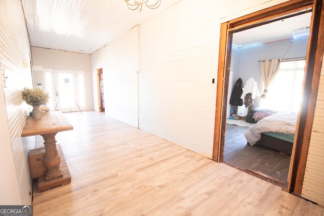 corridor with light hardwood / wood-style floors