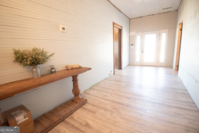 corridor with light hardwood / wood-style floors