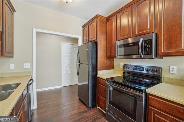 kitchen featuring dark hardwood / wood-style flooring, sink, and stainless steel appliances