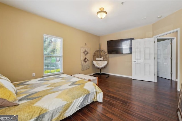 bedroom with dark hardwood / wood-style flooring