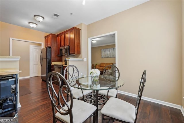 dining space featuring dark hardwood / wood-style flooring