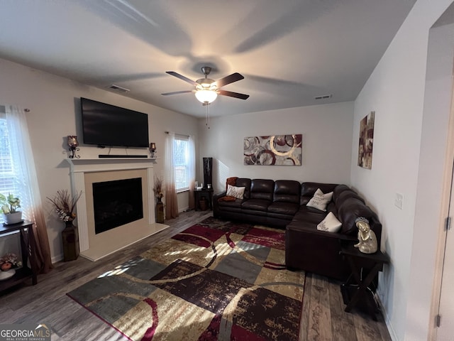 living room with hardwood / wood-style floors and ceiling fan