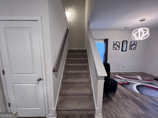 staircase with hardwood / wood-style floors