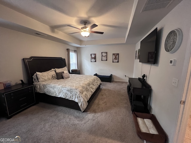 bedroom with ceiling fan, a raised ceiling, and carpet