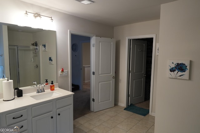 bathroom with vanity, tile patterned flooring, and a shower with door