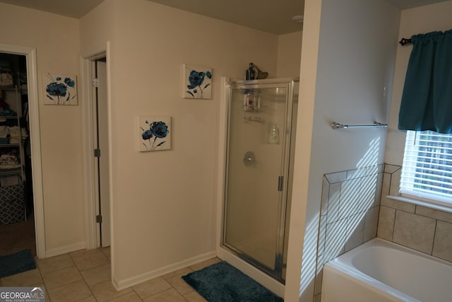 bathroom featuring tile patterned flooring and shower with separate bathtub