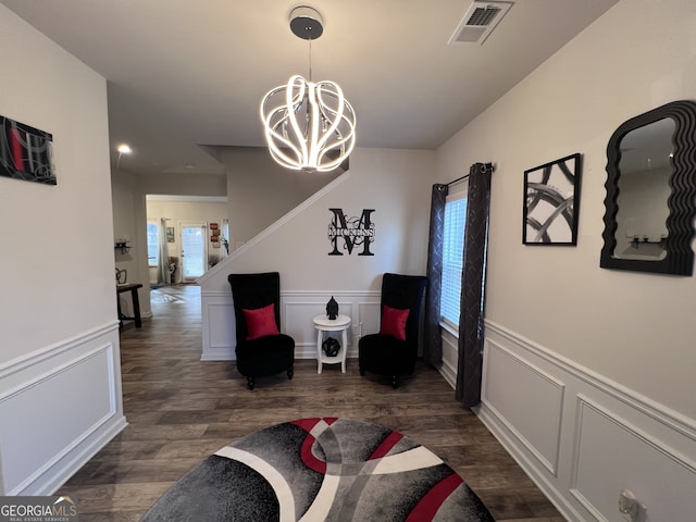 living area with dark hardwood / wood-style flooring and a chandelier