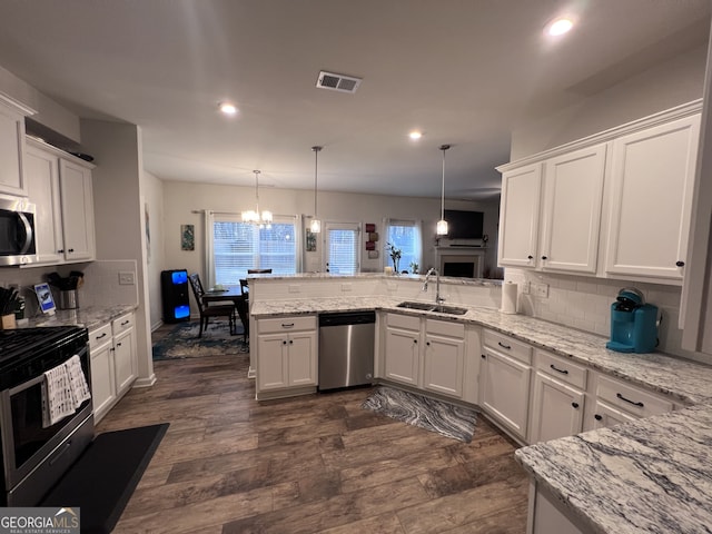 kitchen featuring appliances with stainless steel finishes, white cabinets, and kitchen peninsula