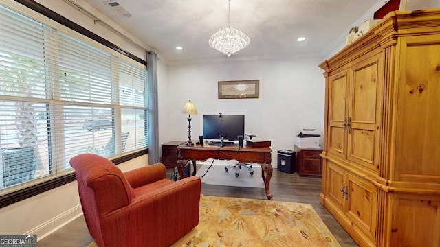 office featuring a notable chandelier, crown molding, and light wood-type flooring