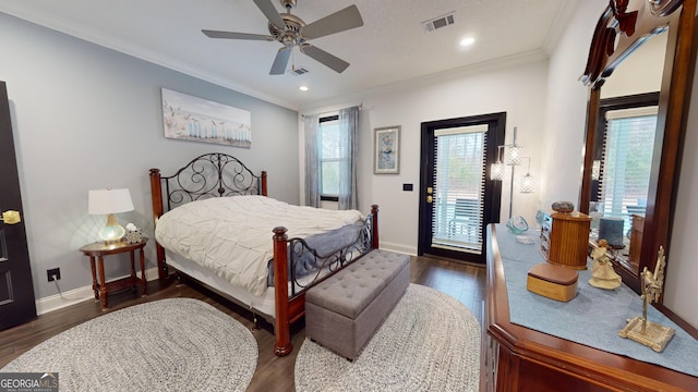 bedroom with dark wood-type flooring, ornamental molding, access to exterior, and multiple windows