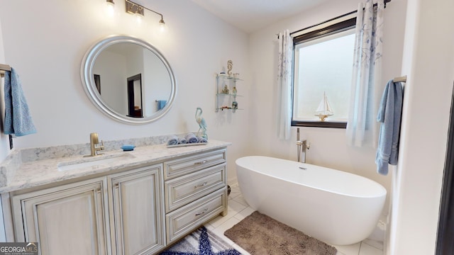 bathroom with vanity, tile patterned floors, and a bathtub