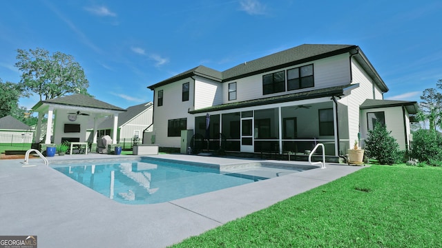 rear view of property featuring a yard, a sunroom, a patio, and ceiling fan