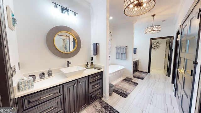 bathroom featuring vanity, ornamental molding, a notable chandelier, and a tub to relax in