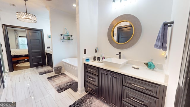 bathroom featuring vanity, a bath, and a chandelier