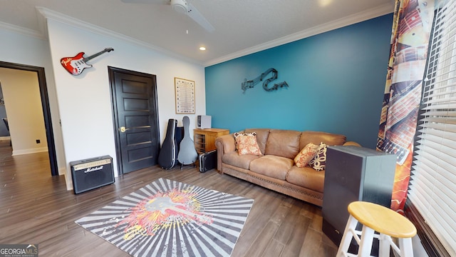 living room with crown molding, hardwood / wood-style floors, and ceiling fan