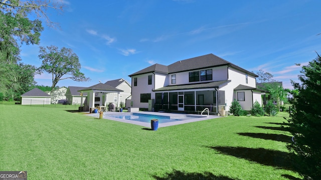 rear view of house with a gazebo, a yard, and a sunroom