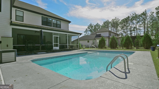 view of swimming pool with a sunroom and ceiling fan