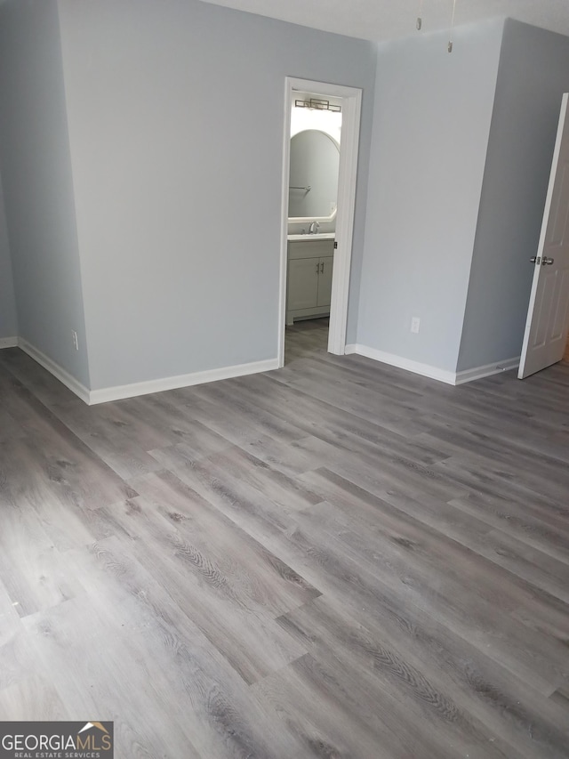 empty room with sink and light hardwood / wood-style flooring