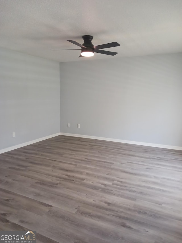 spare room featuring hardwood / wood-style flooring and ceiling fan