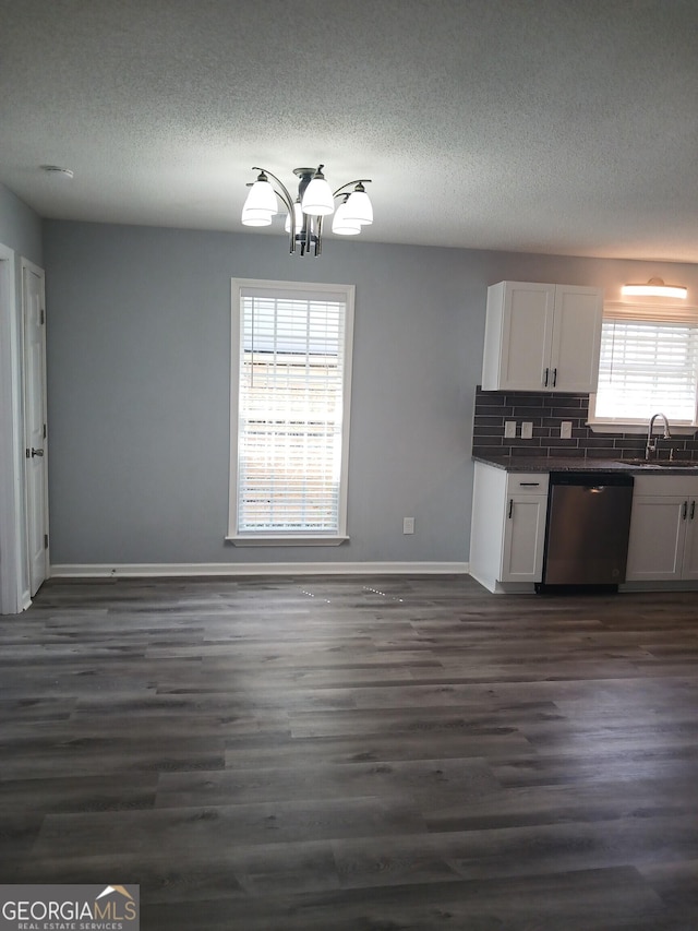 kitchen featuring white cabinetry, sink, stainless steel dishwasher, and dark wood-type flooring