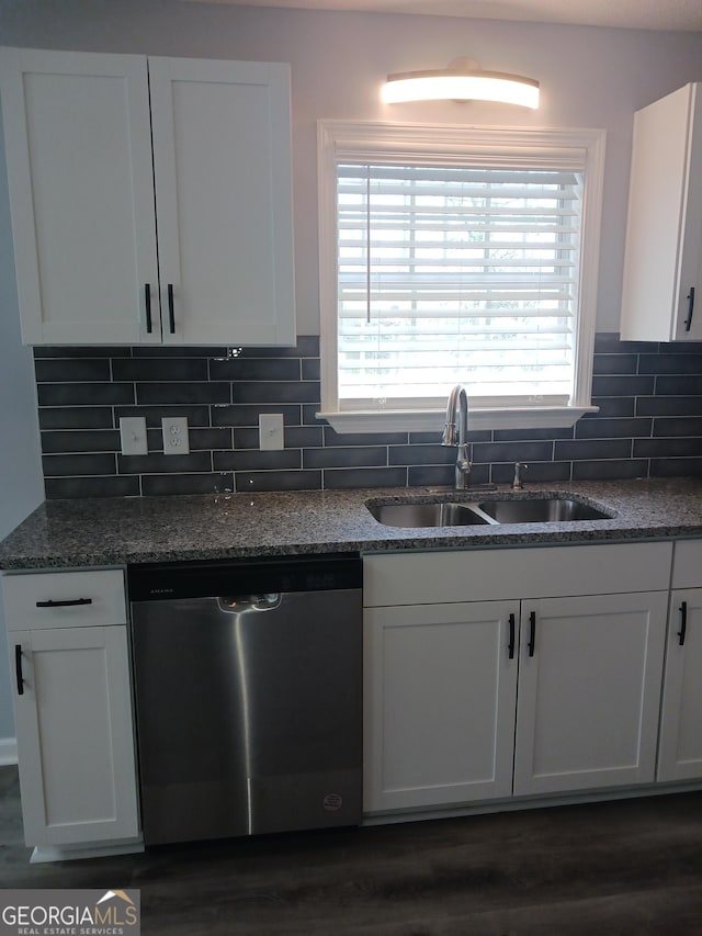 kitchen with tasteful backsplash, white cabinetry, sink, dark stone counters, and stainless steel dishwasher