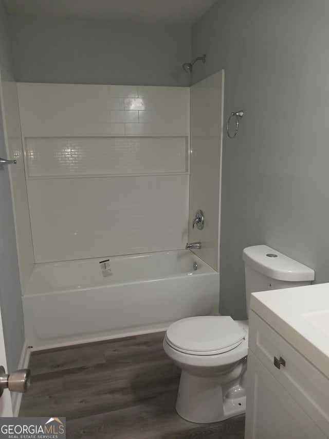 full bathroom with washtub / shower combination, vanity, toilet, and wood-type flooring