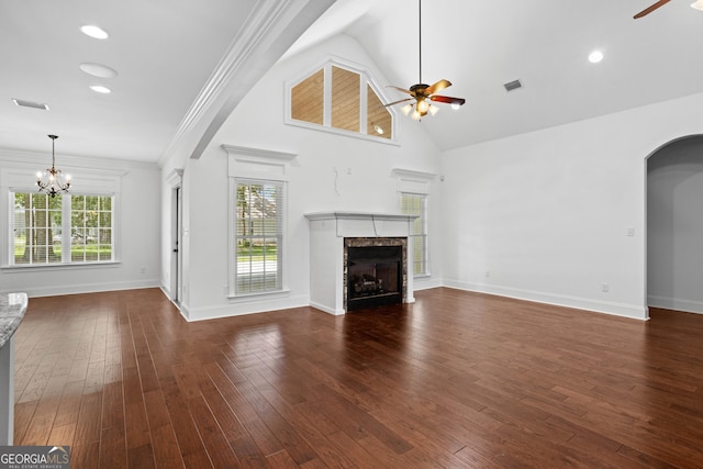 unfurnished living room featuring visible vents, hardwood / wood-style flooring, a fireplace, and ceiling fan with notable chandelier