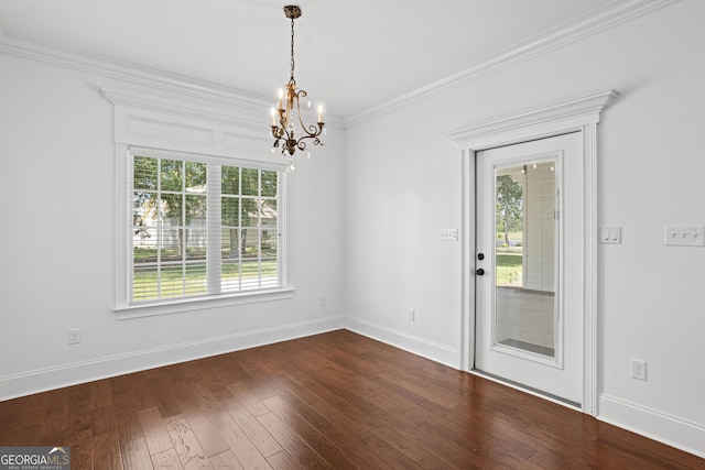 unfurnished dining area with a chandelier, baseboards, dark wood finished floors, and ornamental molding