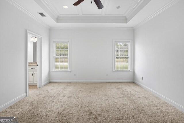 unfurnished bedroom featuring visible vents, light carpet, and multiple windows