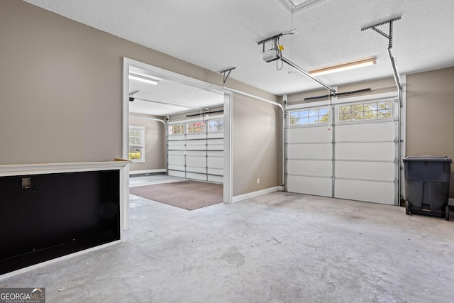 garage with a garage door opener and baseboards