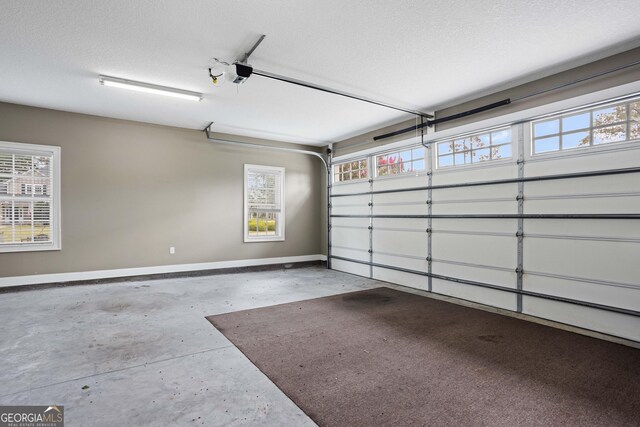 garage with a garage door opener and baseboards