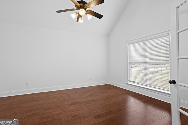 unfurnished room with baseboards, lofted ceiling, dark wood-type flooring, and ceiling fan