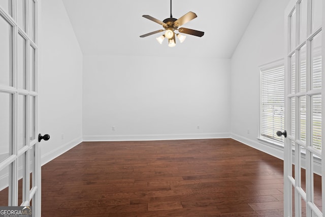 spare room featuring ceiling fan, baseboards, lofted ceiling, french doors, and dark wood-style flooring