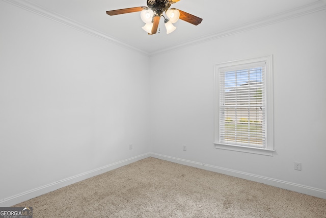 carpeted empty room featuring crown molding, a ceiling fan, and baseboards