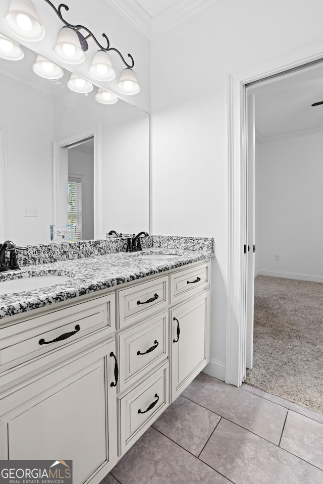 bathroom featuring a sink, double vanity, crown molding, and tile patterned floors