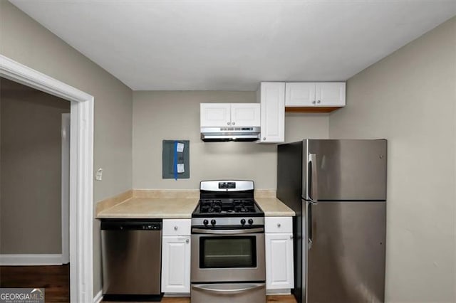 kitchen with stainless steel appliances, dark wood-type flooring, and white cabinets