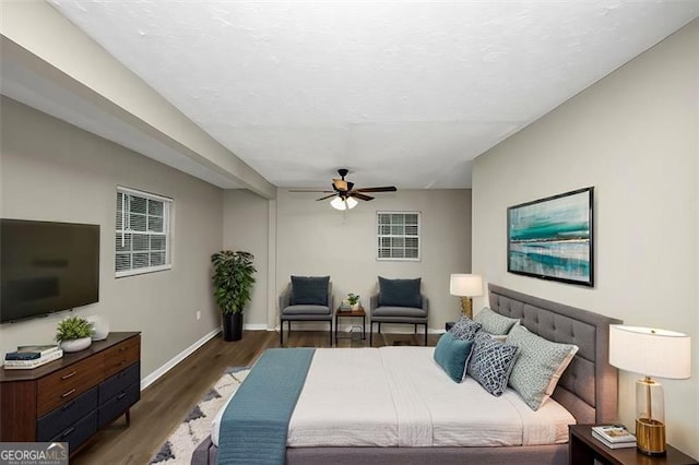 bedroom featuring dark hardwood / wood-style flooring and ceiling fan