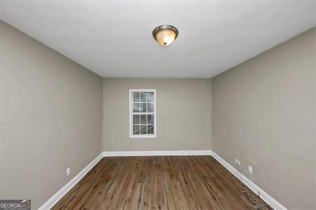 unfurnished room featuring dark wood-type flooring