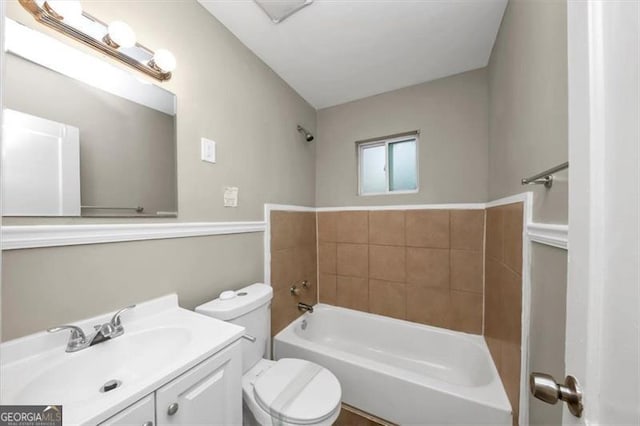 bathroom with vanity, toilet, and a washtub