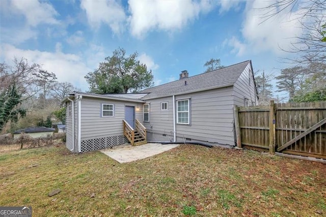 rear view of house featuring a yard and a patio