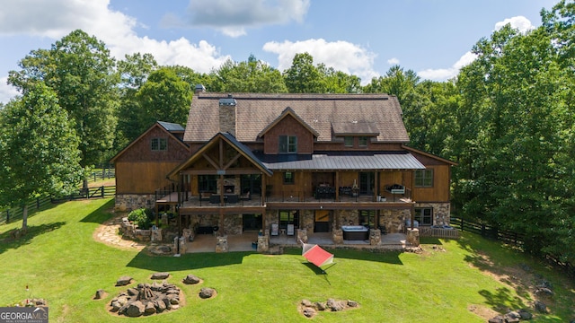 rear view of house with a patio, a yard, and a wooden deck