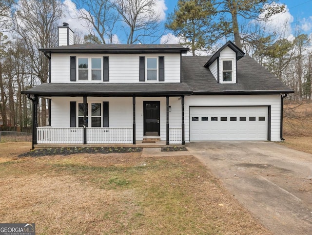 view of front of house featuring a garage, a front yard, and a porch