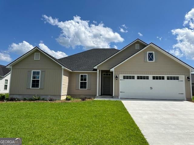 view of front of home with a garage and a front yard